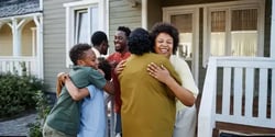 Group_Multiethnic_30s-60s_FamilyHug_HomePorch