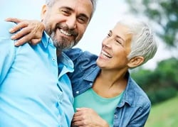 Man_Black_Woman_White_50s-60s_Hugging_OutdoorPark_iStock-1308451693